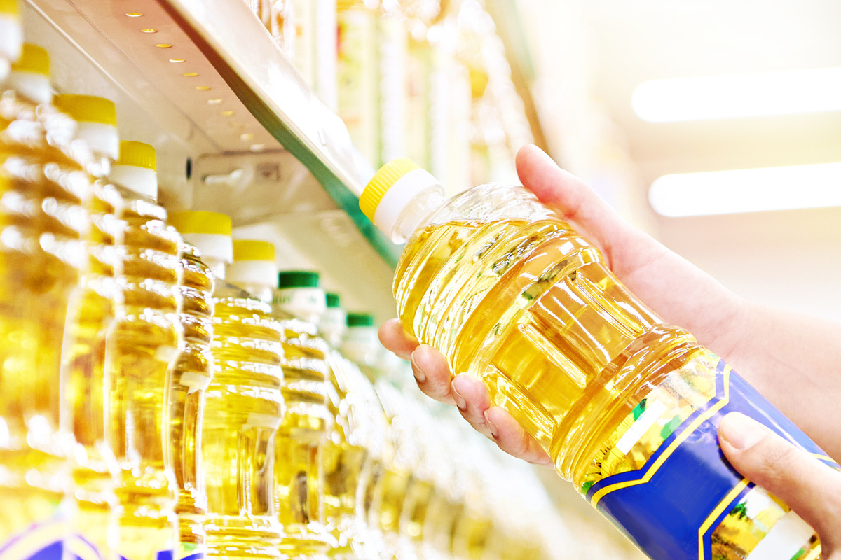 Sunflower oil in hands at store